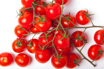 Branch of cherry tomatoes on a white background