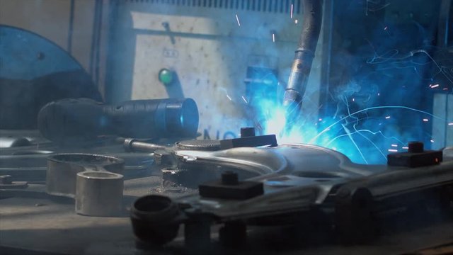 CU shot of robot arm welding car part on a factory. Industrial process, no people. 4K UHD 60 FPS