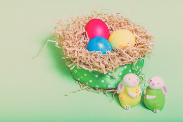 Easter symbols - colored eggs and bunny on light background. Toned