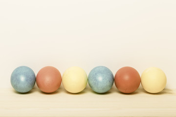 Easter composition on light wooden background. Toned