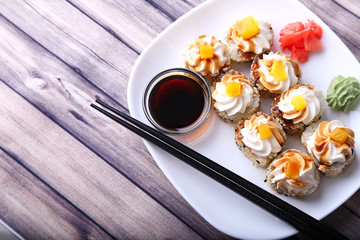 Sushi  on a white plate and wooden texture