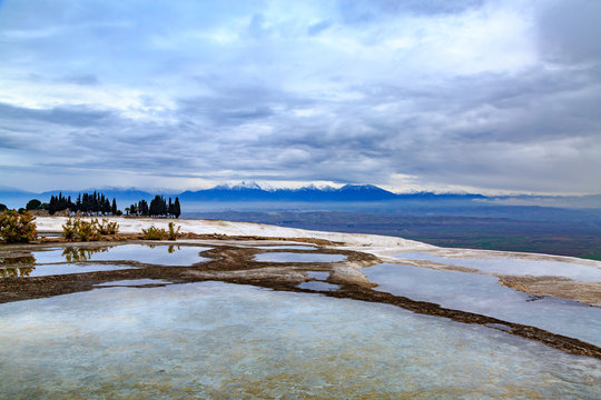 Pamukkale travertines with snowy mountains background