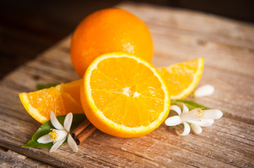 orange and orange blossom on rustic wood background