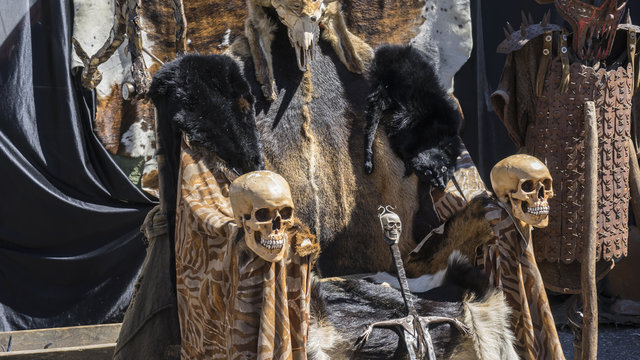 Throne of furs and skulls with a Viking sword. Chair with animal skins
