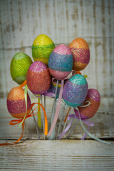 Colorful Easter eggs on metal sticks