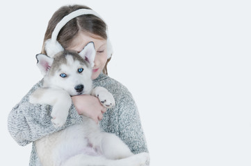 little girl hugging a puppy Husky