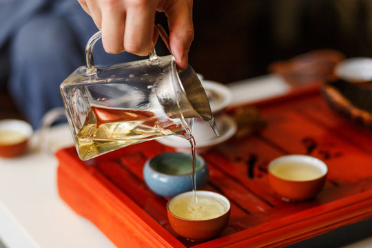 The tea ceremony. The hands of man pouring tea.
