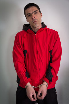Disappointed middle-aged man in handcuffs