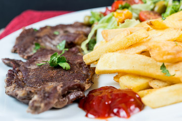 juicy steak beef meat with tomato and french fries