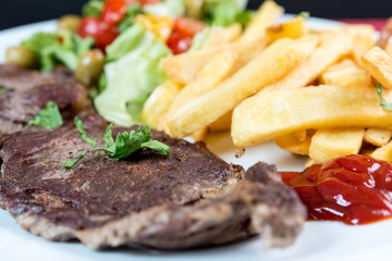 juicy steak beef meat with tomato and french fries