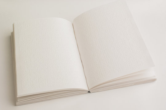 An open book with Braille for blind people. The world day of Braille.