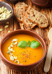 Delicious homemade pumpkin soup with spices and Basil. Vegetarian diet nutrition. Selective focus
