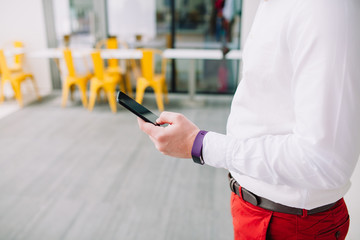 Man using a smartphone. Modern digital concept. Close-up corporate smartphone approach.