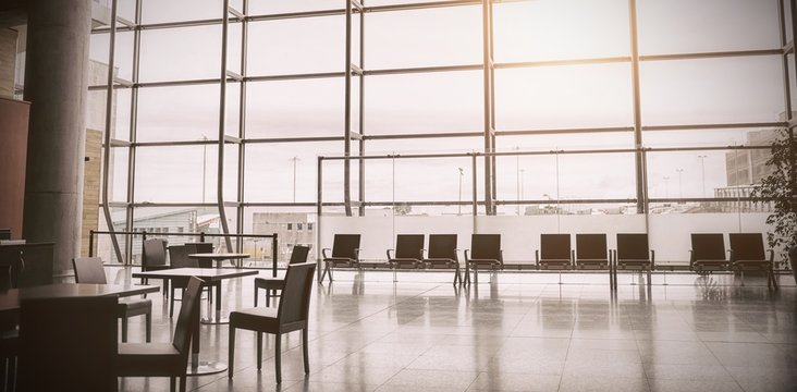 Empty chairs at airport terminal