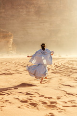 Stylish girl in white dress in Wadi Rum desert in Jordan