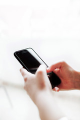 Woman using mobile smartphone. Modern or business concept. Close-up corporate smartphone approach.