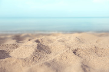 Fototapeta na wymiar Sand beach tropical with blurred sea sky and sunny background, summer day, copy space