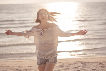 Freedom woman in free happiness bliss on beach, female model Smiling in summer enjoying serene...