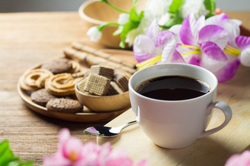 black coffee in white cup with cookie and dessert