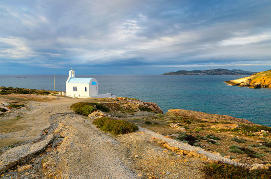 Traditional greek white church on rocky coastline on the Paros Island, Cyclades. Greece.
