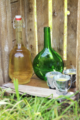Colored wine bottles on the background of a wooden box and grass.