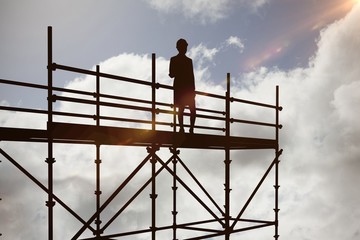 Composite image of smiling architect with hard hat