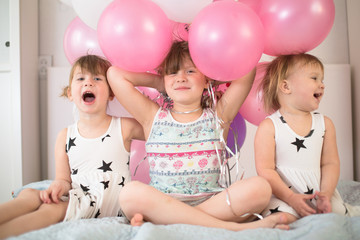 Fototapeta na wymiar funny sisters siblings kids with balloons, holiday
