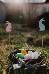 Easter eggs and bunnies in grass. Festive decoration for a Happy Easter.