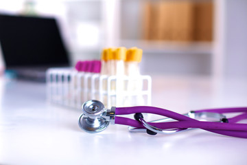 stethoscope near medical tubes on white background