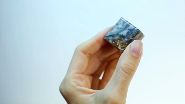 Jasper variegated - jasper stone. Jeweler holding Jasper variegated.