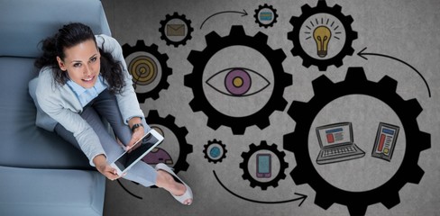 Composite image of woman on her tablet looking up