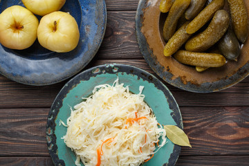 Fermented food, probiotic sources, and space for the text, sauerkraut, pickle, apple. Top view.