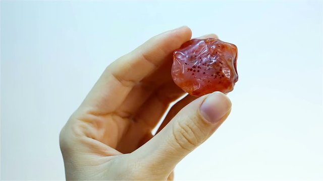 Carnelian  - is the orange banded mineral Chalcedony. Jeweler holding Carnelian