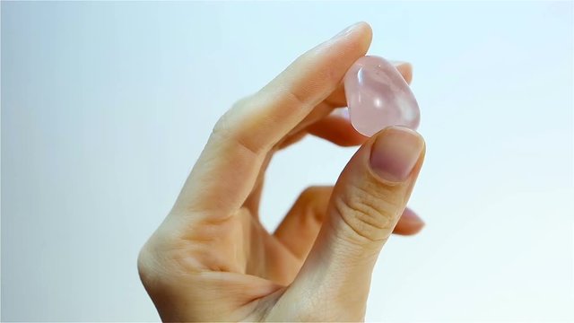 Pink Quartz - a translucent variety of quartz.. Jeweler holding Pink Quartz