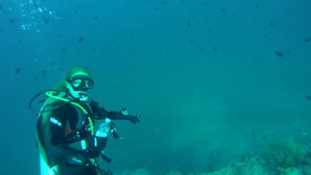Young woman scuba diver shows in depth, Indian Ocean, Maldives, Indian Ocean, Maldives
