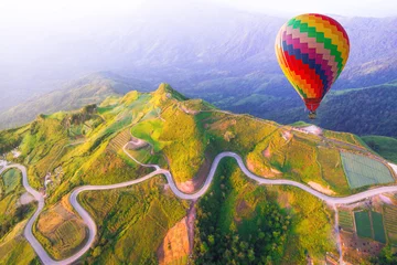 Foto op Canvas Hot air balloon on beautiful mountain © Naypong Studio