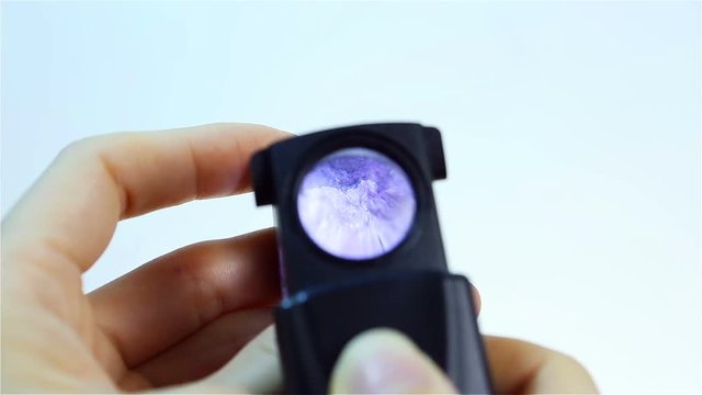 Charoite &ndash; Purple Violet silicate mineral. Jeweler holding Charoite