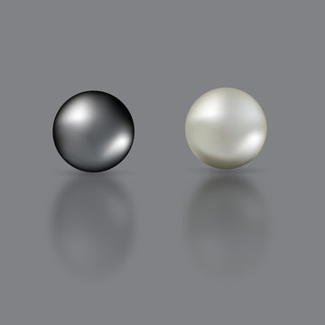 Black and white pearls with mirror reflection isolated on grey background.