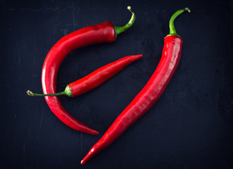 Fresh hot chili peppers on black background, Top view. Close-up