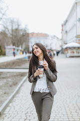 Business women walking on the street and drinking coffee.