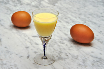 Glass of homemade eggnog with eggs