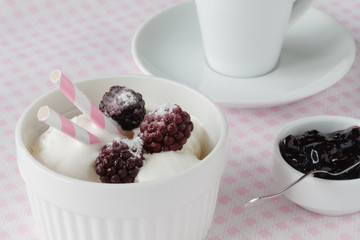 Delicious ice cream with fresh frozen berries and sauce, on color wooden background