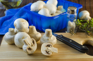mushrooms champignons on the kitchen board