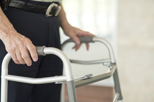 Senior man using walking support frame