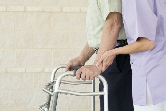 Senior man using walking support frame
