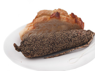 french salami sausage coated with pepper and slices of white bread 