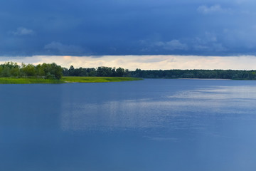 Blue storm clouds over the river. Background, plenty of space for text.