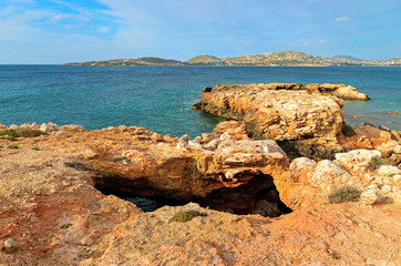 Rocky coast and crystal sea water in Parikia bay on Paros island, Greece.