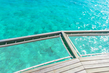 Vacation net seat in tropical Maldives island and beauty of the sea with the coral reefs .