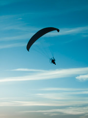 Paragliding in the cloudy sky